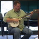 Professor Alex Hooker playing “Cotton Eyed Joe” on the banjo for his Appalachian Strings class. Feb. 14, 2024. Hooker demonstrates how the song is supposed to sound before guiding his students along. Photo by Devon Richter